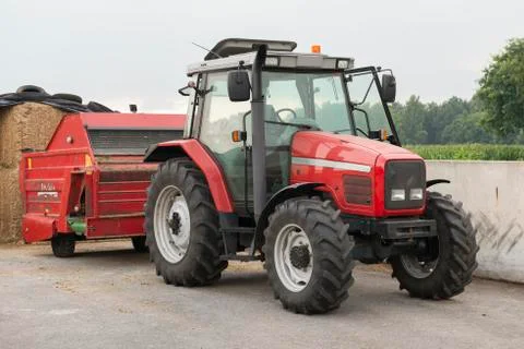 Red tractor with red cattle feed diffuser. Stock Photos