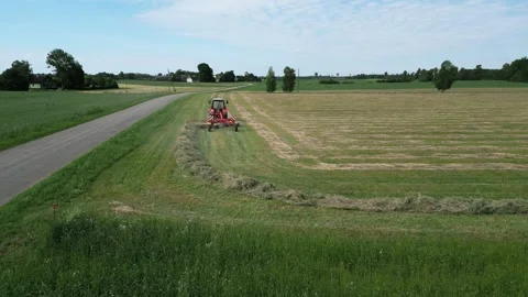 A-red-tractor-with-a-rotary-rake-13-2024-07-01-20-59-02-utc Stock Footage 278431752