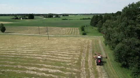 A-red-tractor-with-a-rotary-rake-5-2024-07-01-20-59-01-utc Stock Footage 278431759