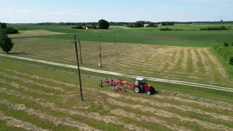 A-red-tractor-with-a-rotary-rake-7-2024-07-01-20-59-02-utc Stock Footage 278431714