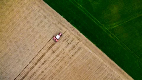 Red tractor sowing Stock Photos