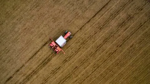 Red tractor sowing Stock Photos