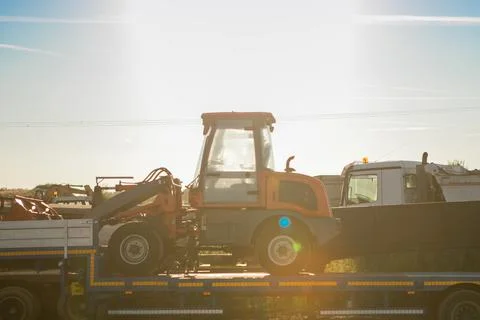 Red tractor in sunset light Stock Photos