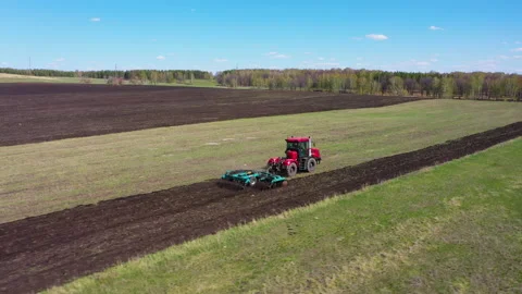 Red tractor working at field Stock Footage 200206677