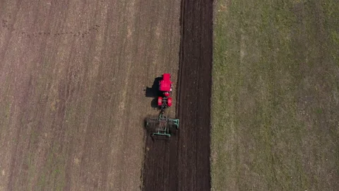 Red tractor working at field Stock Footage 200209642