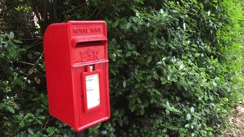 Red traditional small British Post Box - Norfolk countryside - United Kingdom Stock Footage 111667046