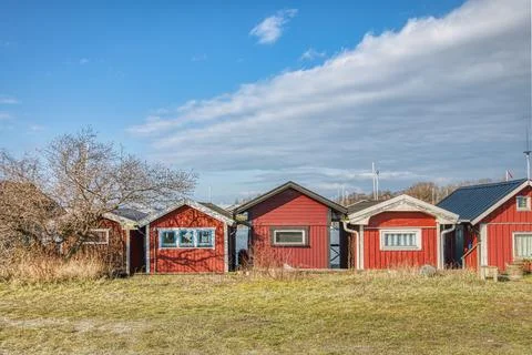 Red, traditional Swedish sommarstuga (summerhouses) or holiday houses in a row Stock Photos