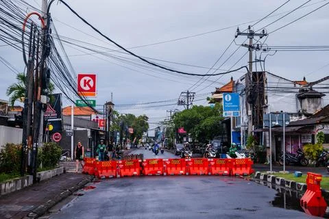 Red Traffic Barriers Blocking a Wet City Street Stock-Fotos