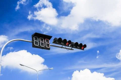 Red traffic light against blue sky Stock Photos