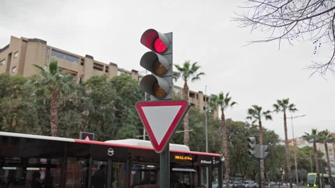 Red traffic light and yield sign on a cloudy day in murcia, spain, with pal.. Stock Footage 273739026
