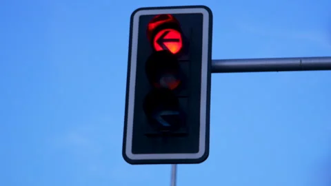 Red Traffic Light Arrow Against Clear Blue Sky In Madrid Stock Footage 343025027