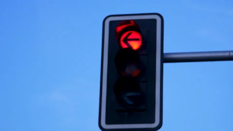 Red Traffic Light With Left Arrow Against Clear Blue Sky In Madrid Stock Footage 343025647