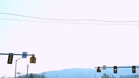 A red traffic light, mountain view, city traffic,  mountain backdrop Видео 273538790