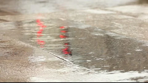 Red traffic light reflection on the wet asphalt. Rainy and raindrops Stock Footage 7138998