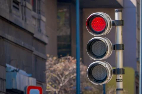 Red traffic light with timer in a blurred city background. City Street Traffic Stock Photos