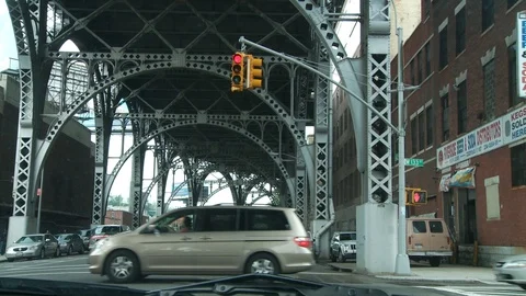 Red traffic light under bridge overpass in Harlem, New York City, day. Video stock 107937504