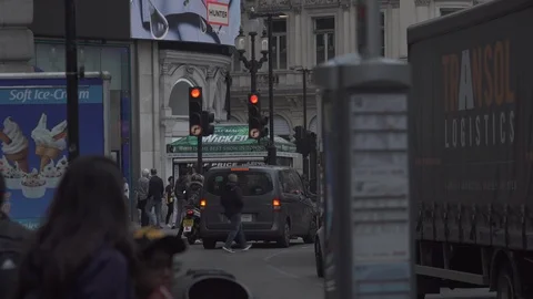 Red traffic lights, van waiting, man running across road. Stock Footage 93207087