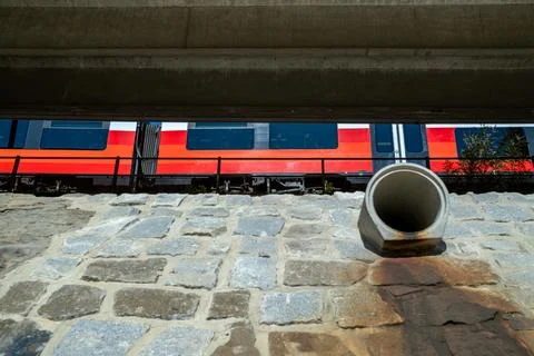 Red train above stone wall Stock Photos