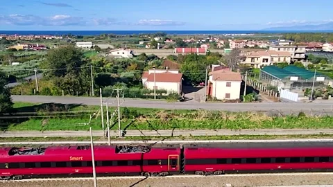 Red Train From a Aerial View. The Movement of the Train at High Speed.  Stock Footage 226738998