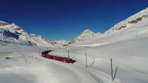 Red train of Bernina, aerial view. Winter landscape Stock Footage 83443591