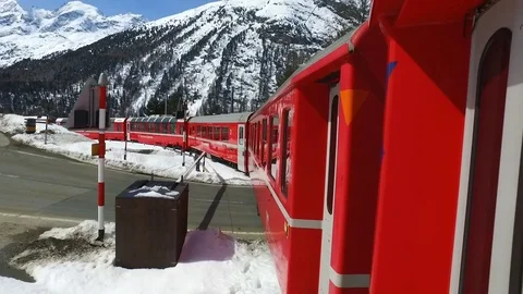 Red train of Bernina, mountain valley view from inside the train. Video stock 88652566