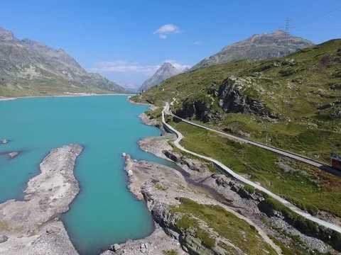 Red train on Bernina Pass in Summer Season Video stock 78342989