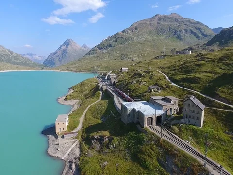 Red train on Bernina Pass - Train Station - Bernina hospice Stock Footage 78343175