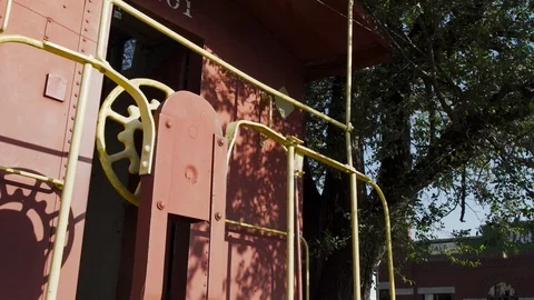 A Red Train Car Sits In A Small Town Stock Footage 87480250