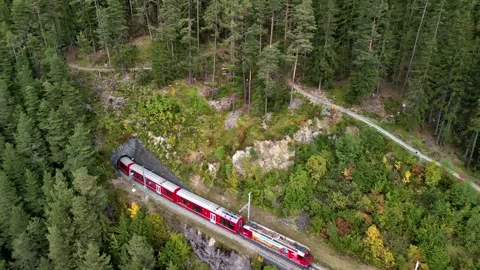 Red Train Crossing Bridge in Autumn Mountain Landscape Stock Footage 294262974