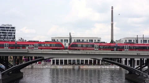 A red train drives over a bridge in Berlin. Stock Footage 221606594