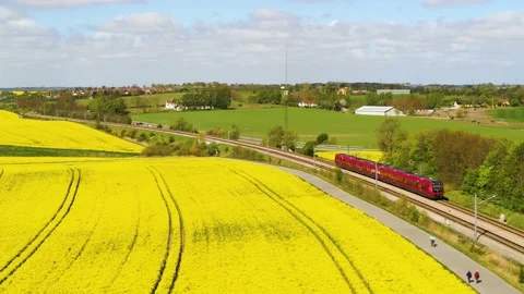 Red train passing by in beautiful landscape 4K Video stock 235449776