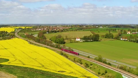 Red train passing by in beautiful landscape drone aerial 4K Stock Footage 235449800