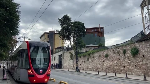 Red train passing by camera in the city Stock Footage 141310477