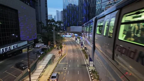 A red train Rapid KL monorail is on a track in a town Stock-Footage 318101668