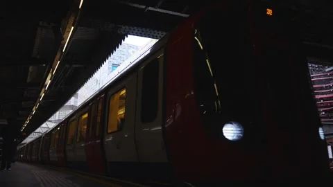 A red train is sitting at a train station Stock Footage 297859361