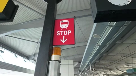 Red Train Stop Sign Board With Arrow Pointer At Station Platform Video stock 338386176
