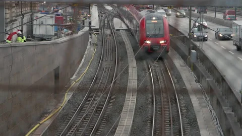 Red train travelling towards the camera on Centralbron in Stockholm, slow motion Stock Footage 143273480