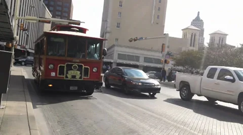 Red tram driving towards camera with traffic - San Antonio Texas Stock Footage 29878706