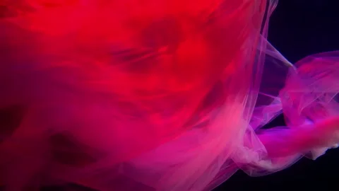 A red translucent fabric sways beautifully in the dark water and fills almost Stock Footage