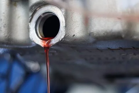 Red Transmission Fluid Draining From Engine Part. Stock Photos