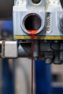 Red Transmission Fluid Flowing From Engine Block. Stock Photos