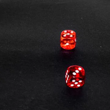 Red transparent dice on black background 写真素材