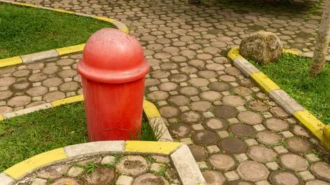 Red trash can garbage bin at the park Stock Photos
