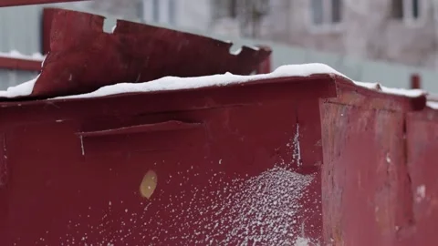 Red trash cans under a layer of snow in winter, close-up. Slow motion Stock Footage 293683993