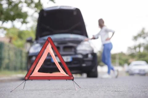 Red triangle of a car on the road Stock Photos