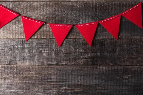 Red triangle flags hanging over wooden background Stock Photos