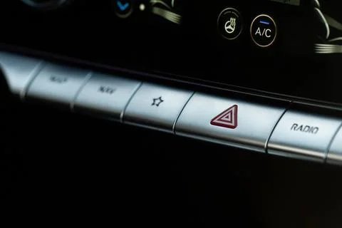 Red triangle hazard light button on car dashboard. Car media buttons dashboar Stock Photos