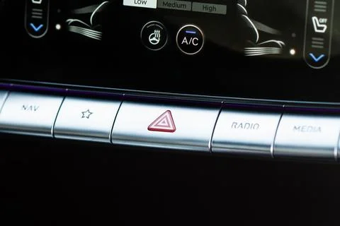 Red triangle hazard light button on car dashboard. Car media buttons dashboar Stock Photos