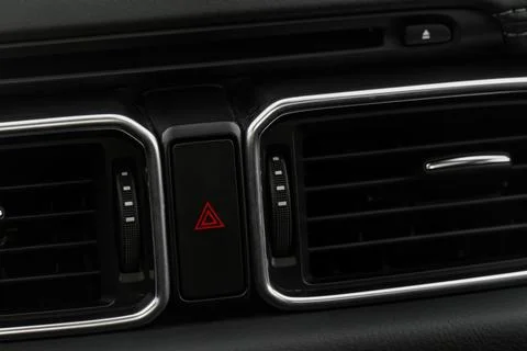 Red triangle hazard light button on car dashboard. Car media buttons dashboar Foto stock