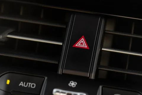 Red triangle hazard light button on car dashboard. Car media buttons dashboar Stock-Fotos